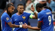France's forward #11 Michael Olise (R, hidden) is congratulated by (L-R) France's defender #17 Malo Gusto, France's forward #10 Kylian Mbappe and France's forward #09 Marcus Thuram after scoring the 0-2 goal during the UEFA Nations League third place play-off football match between Germany and France in Stuttgart, southwestern Germany on June 8, 2025. (Photo by FRANCK FIFE / AFP)
