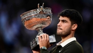 Spain's Carlos Alcaraz holds the trophy after winning the men's singles final match against Italy's Jannik Sinner on day 15 of the French Open tennis tournament on Court Philippe-Chatrier at the Roland-Garros Complex in Paris on June 8, 2025. (Photo by JULIEN DE ROSA / AFP)