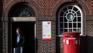 A customer exits a branch of Post Office in Swindon, western England on January 22, 2024. Photo by Adrian DENNIS / AFP