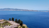 (Files) A general aerial view shows the Sicilian coast towards Cape Torre Faro, over the Strait of Messina, taken from the outskirts of the town of Scilla, in Calabria region in southern Italy, on July 7, 2020. (Photo by Andreas Solaro / AFP)