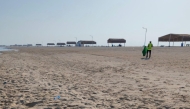 One of the participants clearing the beach of garbage.