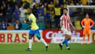 Brazil's forward #10 Vinicius Jr (L) celebrates after scoring his team's first goal past Paraguay's defender #06 Junior Alonso during the 2026 FIFA World Cup South American qualifiers football match between Brazil and Paraguay at the Neo Quimica Arena in Sao Paulo, Brazil, on June 10, 2025. (Photo by Miguel Schincariol / AFP)