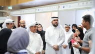 Undersecretary of the Ministry of Education and Higher Education Dr. Ibrahim bin Saleh Al Nuaimi along with other officials interacting with a student of PISQ during the event.