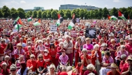 Protestors wave Palestinian flags and signs as they attend a demonstration called by Oxfam Novib, PAX, Amnesty International, Save the Children and Doctors Without Borders in support for the Palestinians, in The Hague on June 15, 2025. (Photo by ANP KOEN VAN WEEL / ANP / AFP)