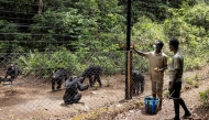 Caretakers feed chimpanzees at the Tacugama Chimpanzee Sanctuary in Freetown, on April 24, 2025. (Photo by Patrick Meinhardt / AFP)