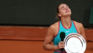 Belarus' Aryna Sabalenka reacts as she poses with her trophy after being defeated by US Coco Gauff in Paris on June 7, 2025. (Photo by Dimitar Dilkoff / AFP)