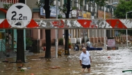 A man walks through a flooded street in Zhongshan, in China's southern Guangdong province on June 17, 2025. Photo by AFP.