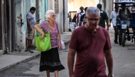 Elderly people walk in a street of Havana, on June 3, 2025. (Photo by Yamil Lage / AFP)