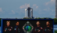 Pictures of the mission astronauts are seen as SpaceX Falcon 9 rocket and Dragon spacecraft sit on the pad of Launch Complex 39A at NASA's Kennedy Space Center ahead of the launch of Axiom Space Mission 4 on June 24, 2025, in Cape Canaveral, Florida. (Photo by Giorgio VIERA / AFP)