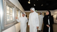 Officials admiring one of the works on display at the exhibition.