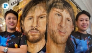 The 100cm x 100cm lenticular painting of the football great is a mixed media artwork that shows both a younger and current Messi, depending on where the viewer stands. Pics: Marivie Alabanza / The Peninsula