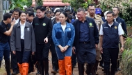 This handout photo from the Royal Thai Government taken and released on June 28, 2025 shows Thailand's Prime Minister Paetongtarn Shinawatra (C) visiting flood-damaged homes in Phaya Mengrai district in Thailand's northern province of Chiang Rai. (Photo by Handout / Royal Thai Government / AFP) 