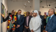 General Manager of the Cultural Village Foundation, Katara Prof. Dr. Khalid bin Ibrahim Al-Sulaiti (second right) and other dignitaries listen to a presentation by Mozambican artist Sebastião Coana (left) at the event.
