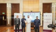 Secretary-General of the National Human Rights Committee Sultan bin Hassan Al-Jamali (second right) presenting a certificate to one of the participants.