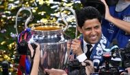 Paris Saint Germain’s President Nasser Al Khelaifi holds the trophy after the club won the UEFA Champions League title, in this May 31 file photo.