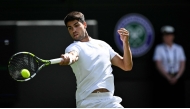 Spain's Carlos Alcaraz plays a forehand return to Britain's Oliver Tarvet during their men's singles second round tennis match on the third day of the 2025 Wimbledon Championships at The All England Lawn Tennis and Croquet Club in Wimbledon, southwest London, on July 2, 2025. (Photo by Kirill KUDRYAVTSEV / AFP)