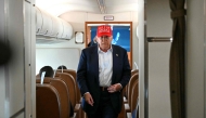 US President Donald Trump walks to speak with the press on board Air Force One as he travels from Ochopee, Florida to Joint Base Andrews, Maryland on July 1, 2025. (Photo by ANDREW CABALLERO-REYNOLDS / AFP)
