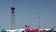Planes are seen on the tarmac of Roissy Charles-de-Gaulle airport, outside Paris, on July 3, 2025, as French air traffic controllers launched a two-day strike to demand better working conditions, disrupting travel for tens of thousands of people at the start of a summer holiday season. Photo by Thibaud MORITZ / AFP.
