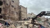Rescuers search for victims in the rubble of a collapsed five-storey residential building in Karachi on July 4, 2025. (Photo by Rizwan TABASSUM / AFP)