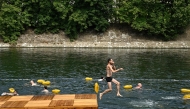 A swimmer jumps in the water at the Grenelle safe bathing site on the Seine river on its opening day, in Paris on July 5, 2025. (Photo by JULIEN DE ROSA / AFP)