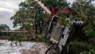  A large truck is impaled onto a tree after flash flooding on the bank Guadalupe River on July 5, 2025 in Center Point, Texas.
(Photo by Jim Vondruska / GETTY IMAGES NORTH AMERICA / Getty Images via AFP)