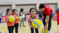 Children practice volleyball.
