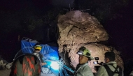 This handout picture released by the Bomberos Voluntarios de Guatemala shows volunteer firefighters working to recover the bodies of two people who died after their vehicle was buried in rocks and soil during a landslide as a result of earthquakes in Santa Maria de Jesus, Guatemala, on July 8, 2025. Photo by Bomberos Voluntarios de Guatemala / AFP