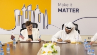 Acting Director General of Qatar Post Hamad Al Fahida  and Chargé d’Affaires at US Embassy Doha Stefanie Altman-Winans signing the agreement.