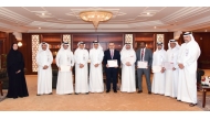 CEO of QIIB Dr. Abdulbasit Ahmed A Al Shaibei with other officials presenting certificates of appreciation to the employees at the bank’s headquarters. 