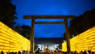 People gather in front of thousands of lanterns on display on the last day of the Mitama Matsuri, one of the capital's largest summer 