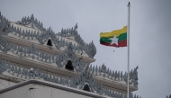 Myanmar's national flag flutters at half-mast outside the City Hall in Yangon on July 19, 2025, on the 78th Martyrs' Day that marks the anniversary of the assassination of independence leaders, including general Aung San, father of the currently deposed and imprisoned leader Aung San Suu Kyi. (Photo by AFP)


