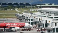 An Air Asia Airbus A320 aircraft is seen on the tarmac at the Kuala Lumpur International Airport's low-cost carrier terminal in Sepang on March 8, 2022. (Photo by Arif Kartono / AFP)
