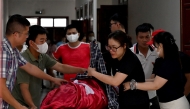Relatives move the body of a victim after a tourist boat capsized in Ha Long Bay, at a funeral home in Ha Long, Quang Ninh province on July 20, 2025. Photo by Nhac NGUYEN / AFP