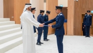 Minister of Interior and Commander of the Internal Security Force (Lekhwiya) - Chairman of the Supreme Council of the Police Academy H E Sheikh Khalifa bin Hamad bin Khalifa Al-Thani presenting certificate to a graduate during the ceremony.