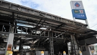 Damage from a fire caused by Cambodian artillery at a 7-11 convenience store is seen at a PTT gas station in the Thai border province of Sisaket province on July 25, 2025. (Photo by Lillian SUWANRUMPHA / AFP)
