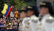 People cheer during the military parade to commemorate Colombia's Independence Day in Bogota on July 20, 2025. (Photo by Luis ACOSTA / AFP)
