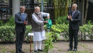 The President of Maldives Mohamed Muizzu (R) reacts as India's Prime Minister Narendra Modi (C) plants a tree sapling during his state visit in Male on July 25, 2025. (Photo by Mohamed Afrah / AFP)
