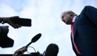 US President Donald Trump speaks to the press after disembarking from Air Force One upon his arrival at Prestwick Airport, south of Glasgow on July 25, 2025, on the first day of his UK visit. (Photo by Brendan SMIALOWSKI / AFP)
