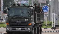 Royal Thai Army soldiers are transported on the back of an army truck in the Thai border province of Si Sa Ket on July 26, 2025. (Photo by Lillian SUWANRUMPHA / AFP)
