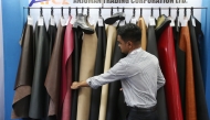 An exhibitor arranges leather products at the 9th edition of Bangladesh Leather and Footwear Expo in Dhaka, Bangladesh, on July 24, 2025. (Photo by Habibur Rahman/Xinhua)
