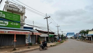 Women ride along a quiet street in Samraong, some 20 kilometres from the border conflict zone, in Cambodia's Oddar Meanchey province on July 27. (Photo by TANG CHHIN Sothy / AFP)