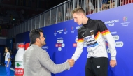 Qatar Olympic Committee President H E Sheikh Joaan bin Hamad Al Thani shakes hands with the men’s 400m freestyle gold medallist Lukas Maertens of Germany.