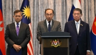 Malaysia's Prime Minister Anwar Ibrahim (C) speaks during a press conference next to Cambodia's Prime Minister Hun Manet (L) and Thailand's acting Prime Minister Phumtham Wechayachai (R) after talks on a possible ceasefire between Thailand and Cambodia in Putrajaya on July 28, 2025. Photo by MOHD RASFAN / POOL / AFP