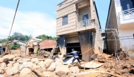 This photo taken by the Vietnam News Agency (VNA) on July 28, 2025 shows rescue workers clearing debris following flash floods in Son La province in northern Vietnam. Photo by Vietnam News Agency / AFP
