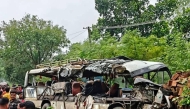 People gather near a wrecked bus at the site of a road accident in the Deoghar district of India's Jharkhand state on July 29, 2025. Photo by AFP