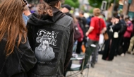 Mourners and music fans line the streets ready to pay their respects, before the funeral cortege of Ozzy Osbourne, the late lead singer of Black Sabbath, makes its way through Birmingham, central England on July 30, 2025. Photo by Ben STANSALL / AFP