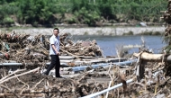 A man walks past a rain damaged area from the past few days in Huairou district, on the outskirts of Beijing on July 30, 2025. Photo by Pedro Pardo / AFP