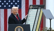 US President Donald Trump holds a chart as he delivers remarks on reciprocal tariffs during an event in the Rose Garden entitled 