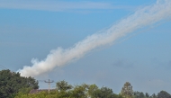 Smoke is pictured in the air from a multi-rocket launcher near the Cambodia-Thailand border in Oddar Meanchey province on July 25, 2025. (Photo by TANG CHHIN Sothy / AFP)
