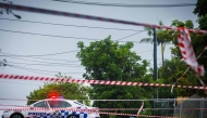 File photo for representational purposes. Police cordons are displayed to stop traffic after power lines fell across a road in Coorparoo in Brisbane on March 8, 2025, as cyclone Alfred crossed the southeast Queensland coast. (Photo by Patrick Hamilton / AFP)